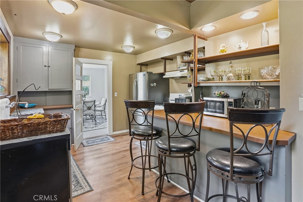 6701 East Zayante Road Felton, CA 95018 - Photo 39 of 44 a kitchen with stainless steel appliances kitchen island granite countertop a table chairs stove and a refrigerator