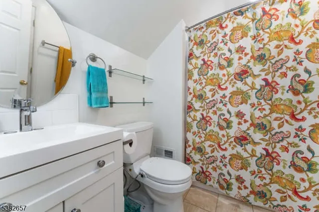 a bathroom with a sink toilet and mirror