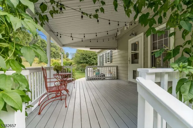 a view of a patio with table and chairs potted plants with wooden floor