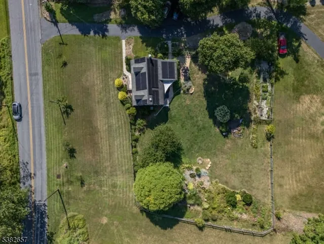 a backyard of a house with a yard and outdoor seating