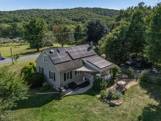 an aerial view of a house with a yard basket ball court and outdoor seating