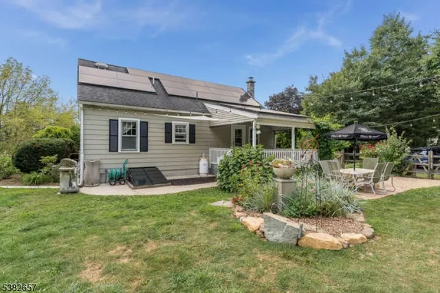 a front view of a house with a yard garage and outdoor seating