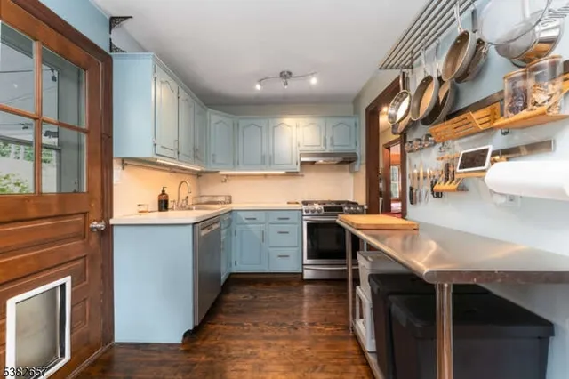 a kitchen with a sink stove and cabinets