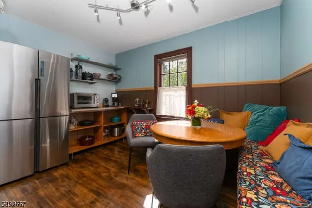 a dining room with furniture and a window