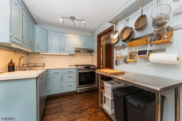 a kitchen with stainless steel appliances granite countertop a sink and cabinets