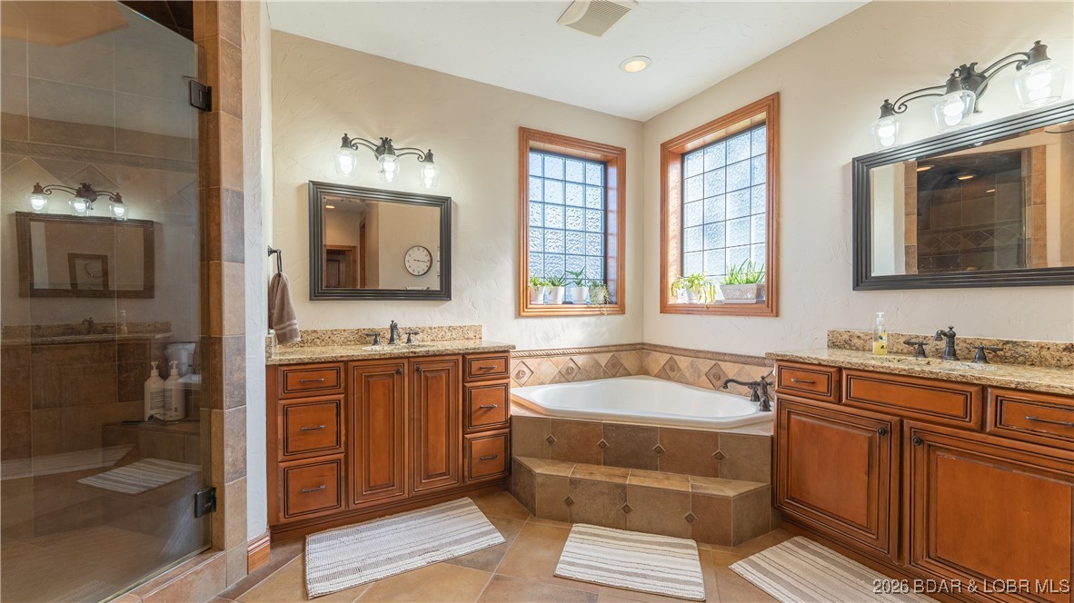 5745 Tree Leaf Court Osage Beach, MO 65065 - Photo 25 of 49 Primary bath... Dual vanity with jetted tub