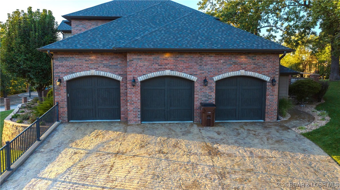 5745 Tree Leaf Court Osage Beach, MO 65065 - Photo 3 of 49 Stamped concrete driveway w/ 3car garage