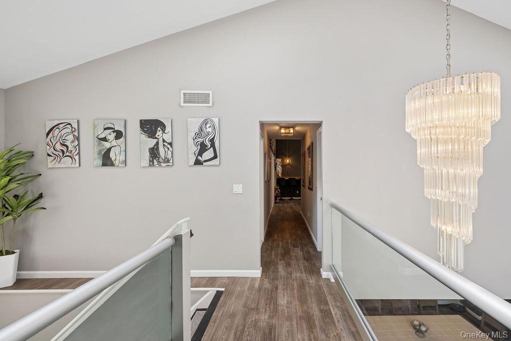 30 Lone Oak Path Smithtown, NY 11787 - Photo 13 of 39 a view of a hallway with wooden floor and stairs