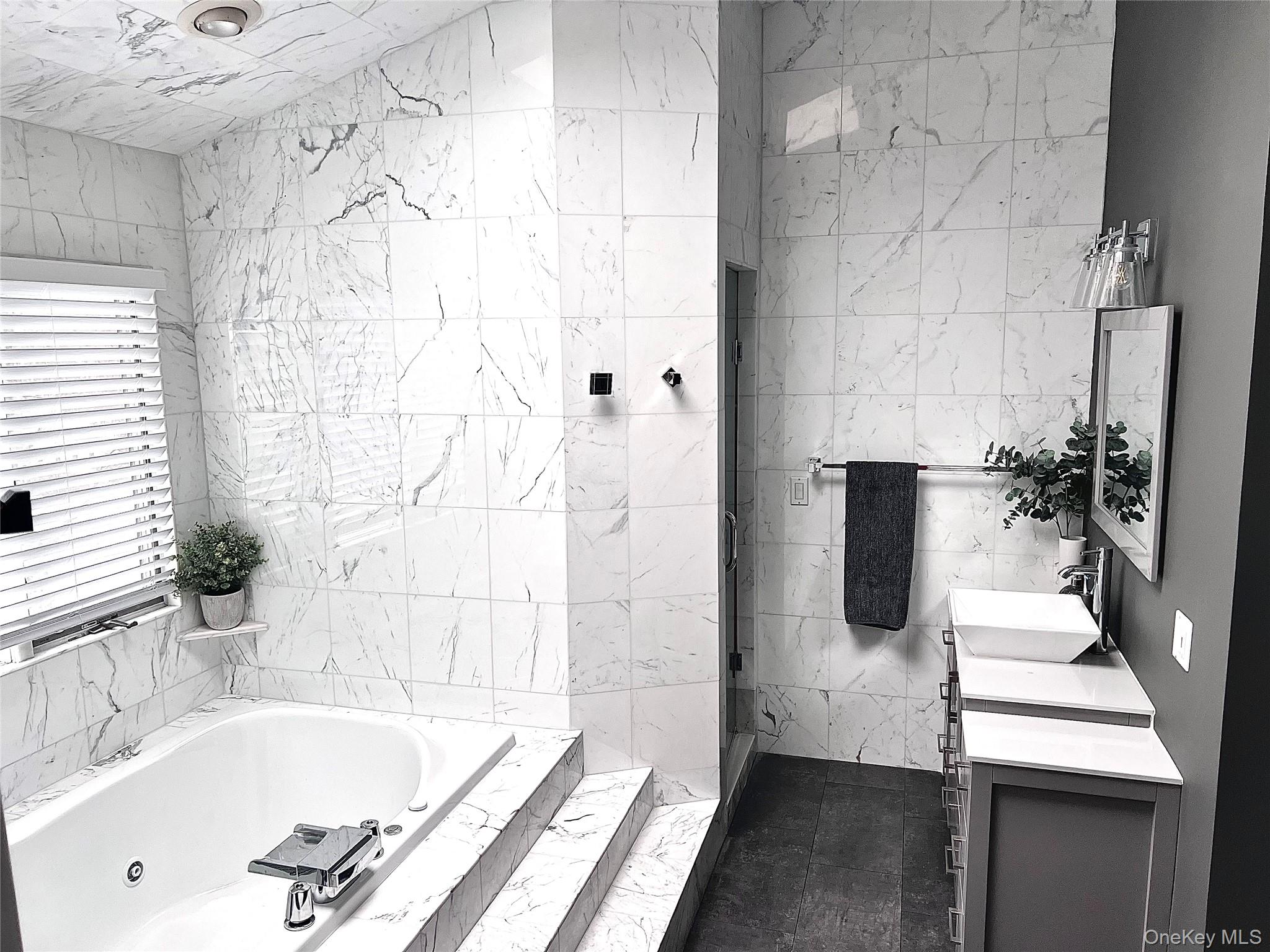 30 Lone Oak Path Smithtown, NY 11787 - Photo 17 of 39 a bathroom with a bathtub and a sink