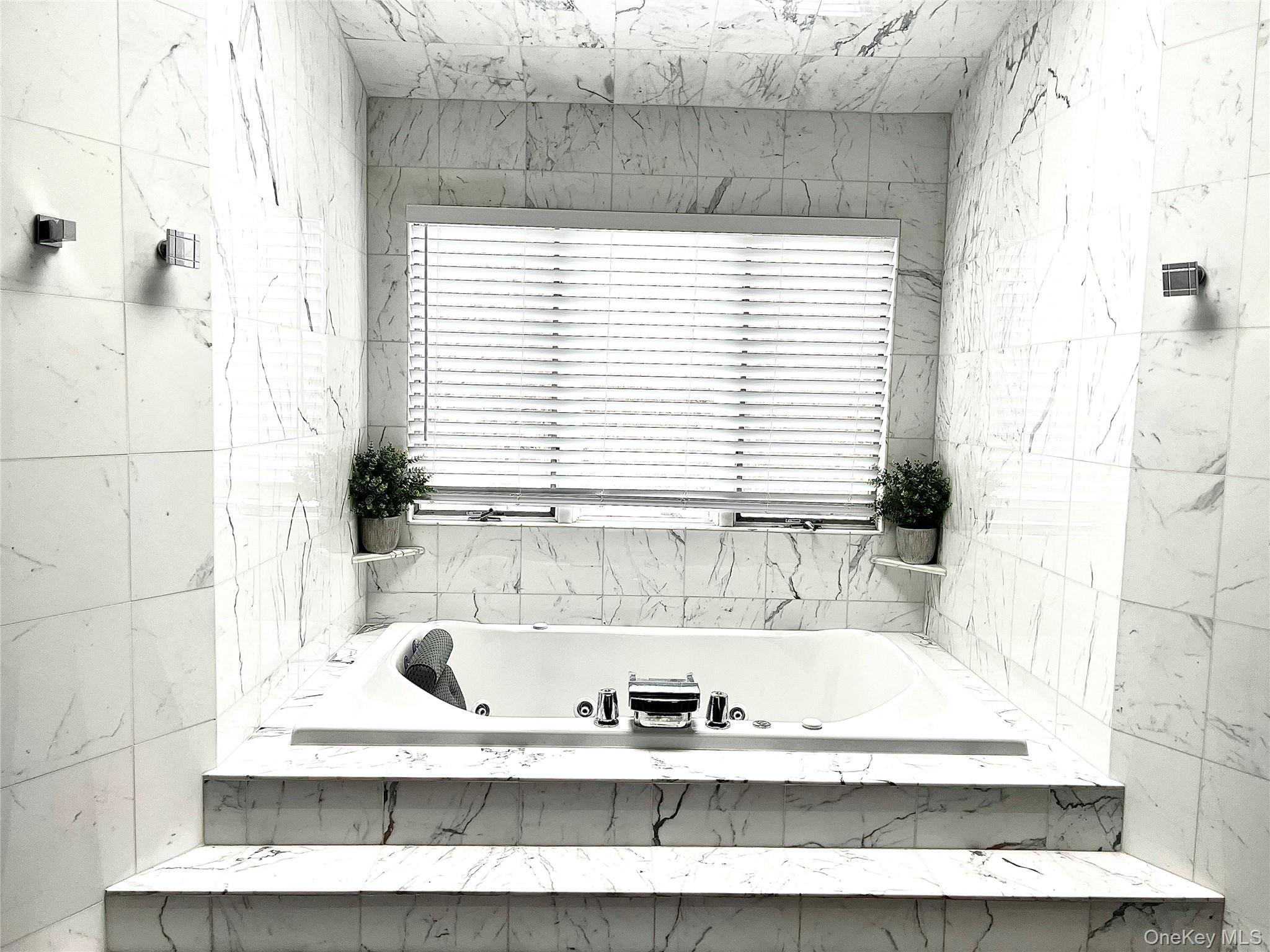 30 Lone Oak Path Smithtown, NY 11787 - Photo 18 of 39 a view of a bathtub in a bathroom