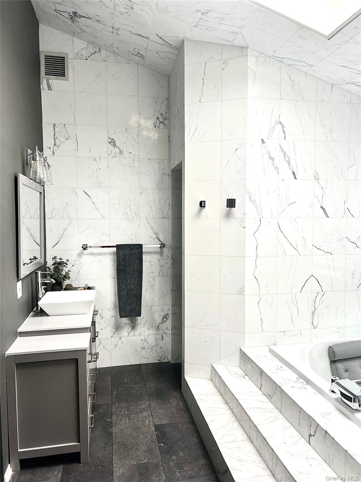 30 Lone Oak Path Smithtown, NY 11787 - Photo 19 of 39 a bathroom with a sink and a mirror