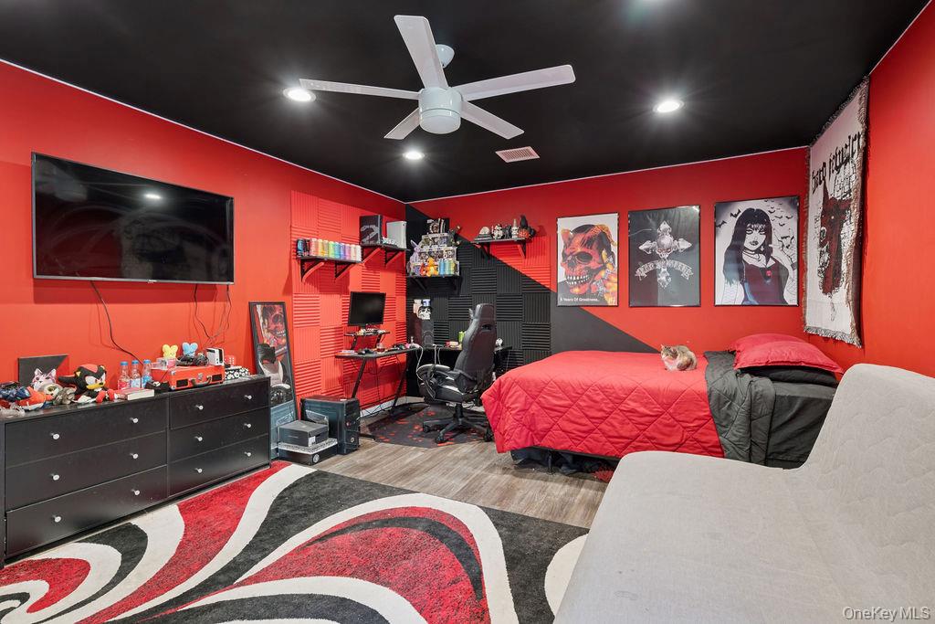 30 Lone Oak Path Smithtown, NY 11787 - Photo 20 of 39 a bedroom with a bed and a flat screen tv