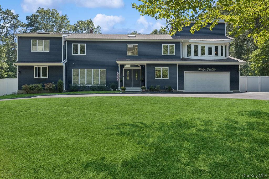 30 Lone Oak Path Smithtown, NY 11787 - Photo 2 of 39 a front view of brick house with a yard
