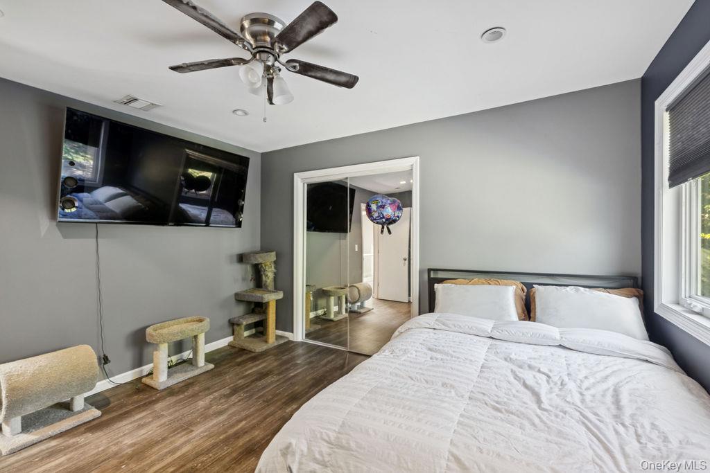 30 Lone Oak Path Smithtown, NY 11787 - Photo 22 of 39 a bedroom with a bed and wooden floor