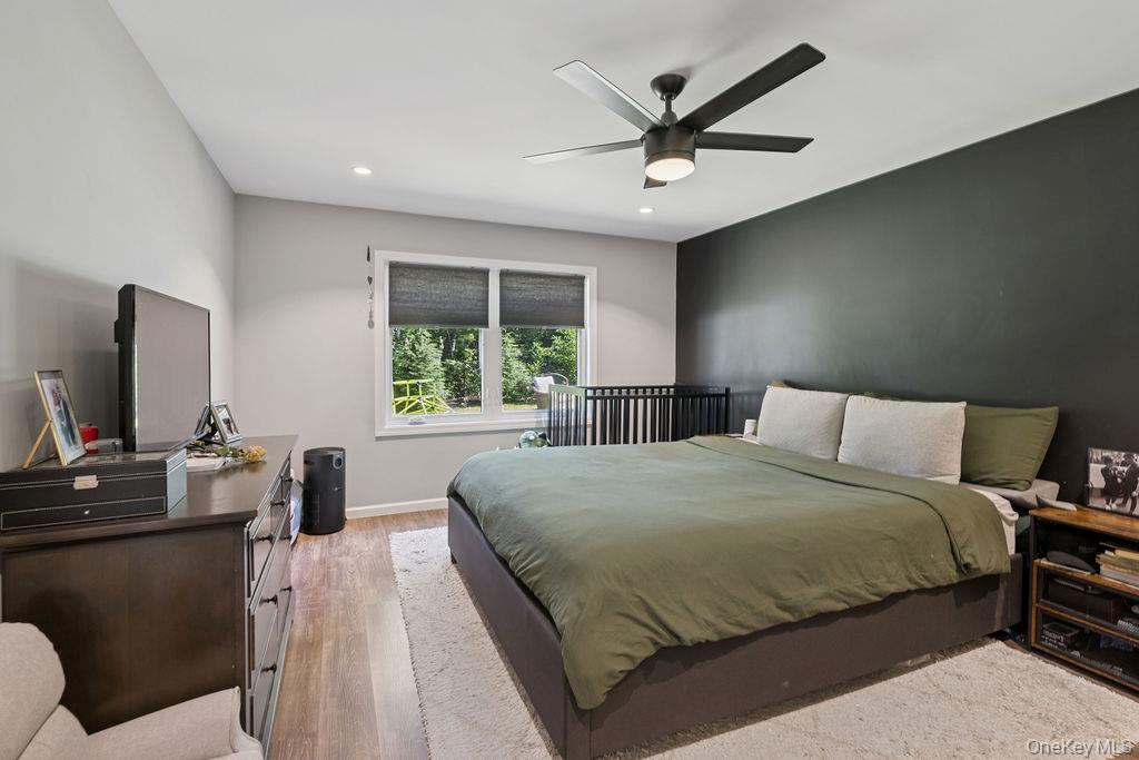 30 Lone Oak Path Smithtown, NY 11787 - Photo 27 of 39 a bedroom with a bed and a flat screen tv