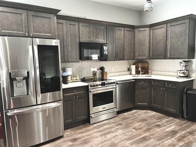 30 Lone Oak Path Smithtown, NY 11787 - Photo 28 of 39 a kitchen with a sink stove and refrigerator
