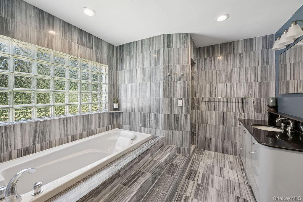 30 Lone Oak Path Smithtown, NY 11787 - Photo 30 of 39 a bathroom with a bathtub and a shower