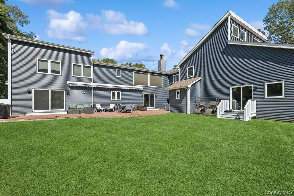 30 Lone Oak Path Smithtown, NY 11787 - Photo 3 of 39 a front view of house with yard and porch