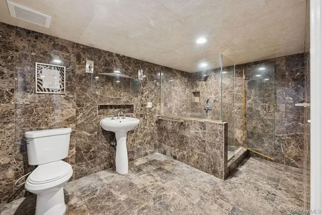 a bathroom with a toilet sink and shower