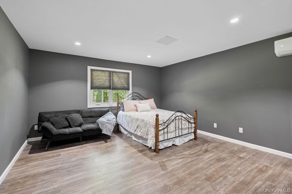 30 Lone Oak Path Smithtown, NY 11787 - Photo 32 of 39 a bed room with furniture and a window