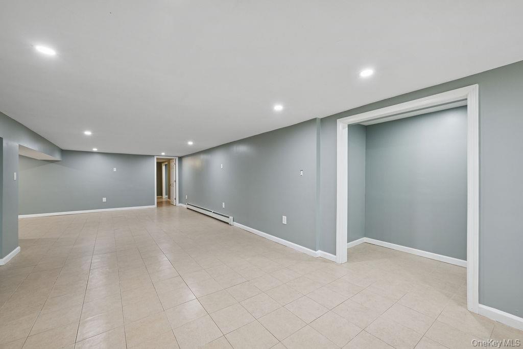 30 Lone Oak Path Smithtown, NY 11787 - Photo 34 of 39 an empty room with wooden floor