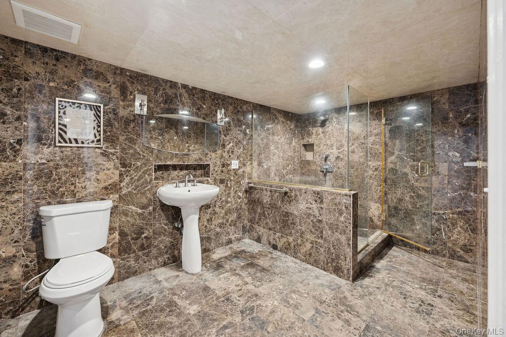 30 Lone Oak Path Smithtown, NY 11787 - Photo 36 of 39 a bathroom with a toilet sink and shower
