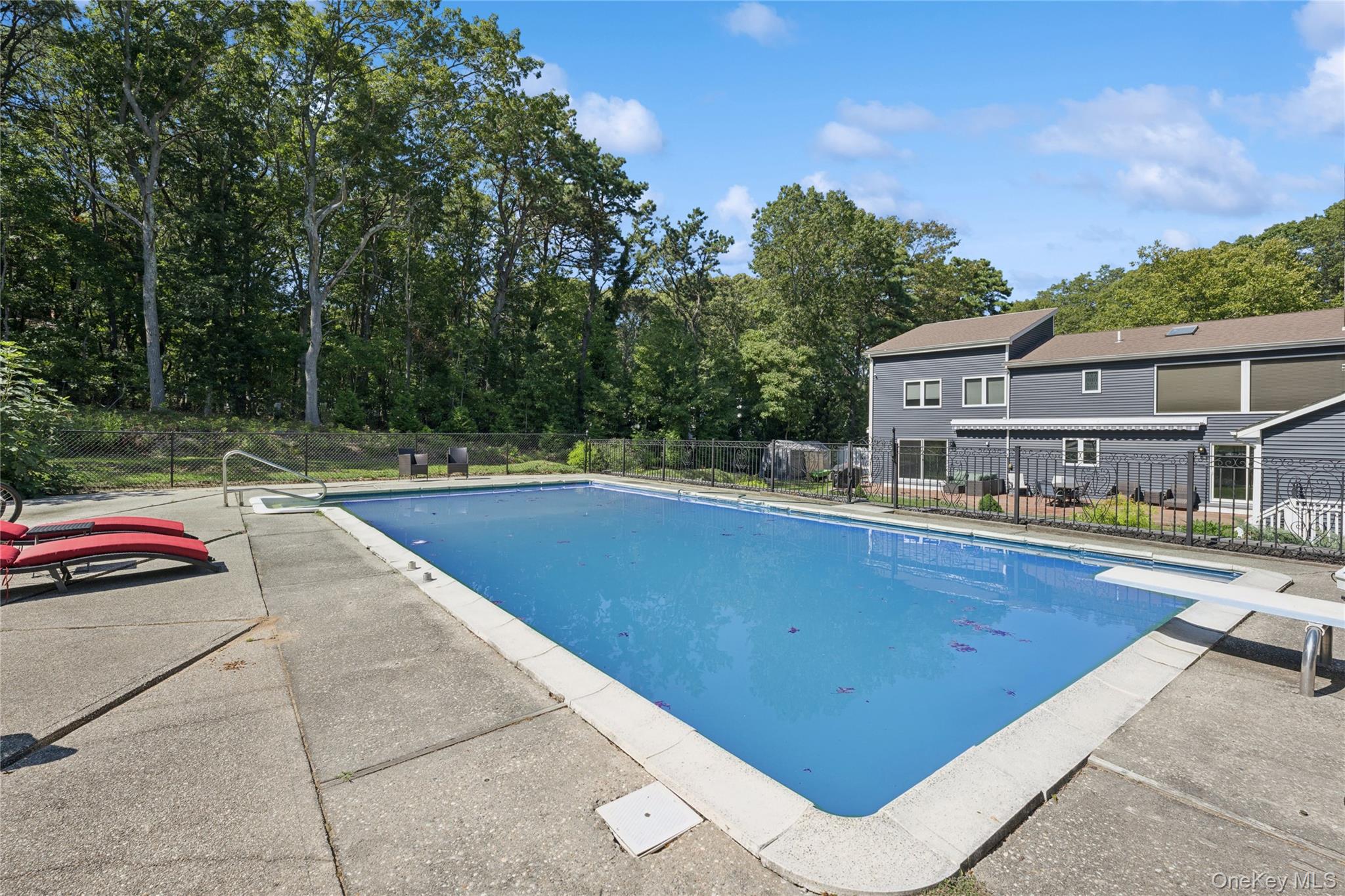 30 Lone Oak Path Smithtown, NY 11787 - Photo 37 of 39 a view of backyard with swimming pool and seating space