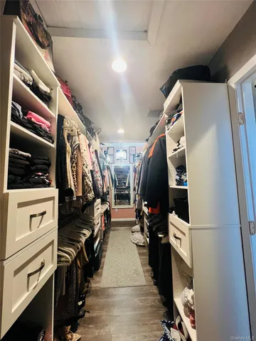 a view of swimming pool with a yard and large trees