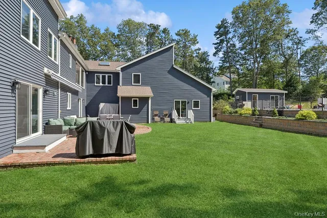 a view of a house with a yard and sitting area