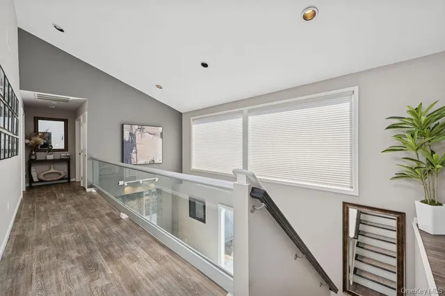 a view of a hallway with entryway and stairs