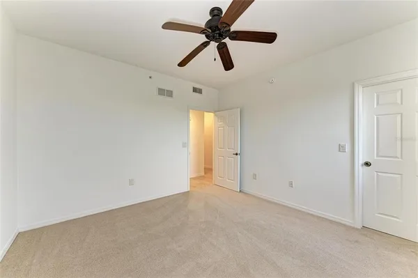 a view of a patio with chairs and potted plants