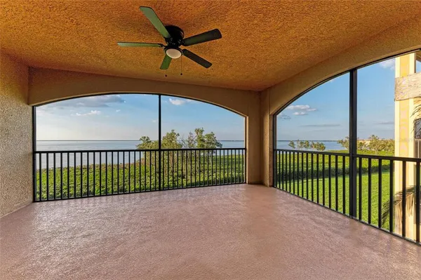 a view of a patio with a table and chairs under an umbrella