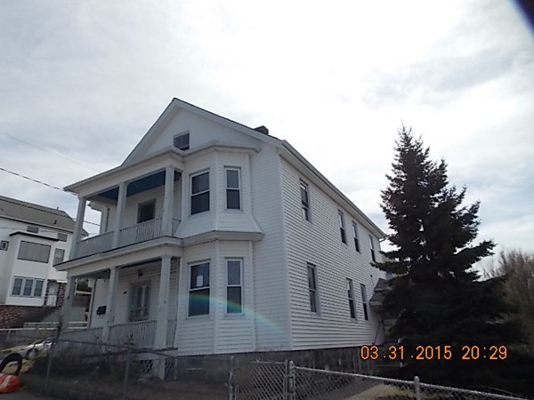 77 Langley Street Fall River, MA 02720 - Photo 2 of 10 a large white building with a large window