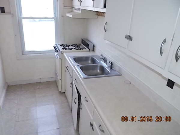 77 Langley Street Fall River, MA 02720 - Photo 4 of 10 a kitchen that has a sink and a stove