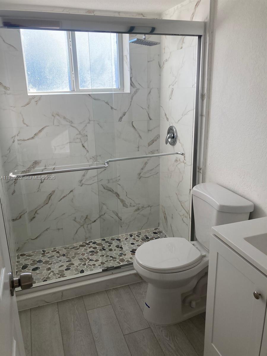 199 East McNab Road, Unit 101 Pompano Beach, FL 33060 - Photo 8 of 15 a bathroom with a toilet and a shower