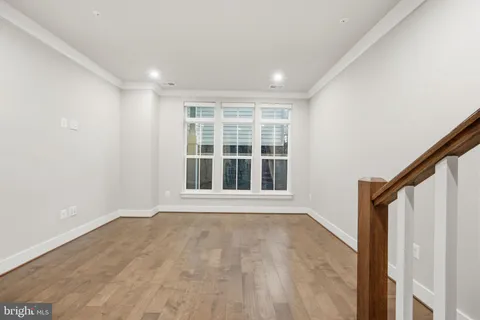 a large kitchen with stainless steel appliances granite countertop a lot of cabinets and wooden floor