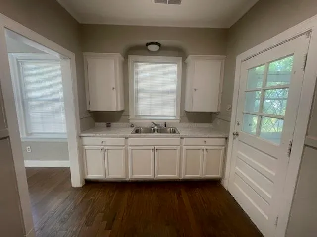 a bathroom with granite countertop white cabinets and a granite counter tops