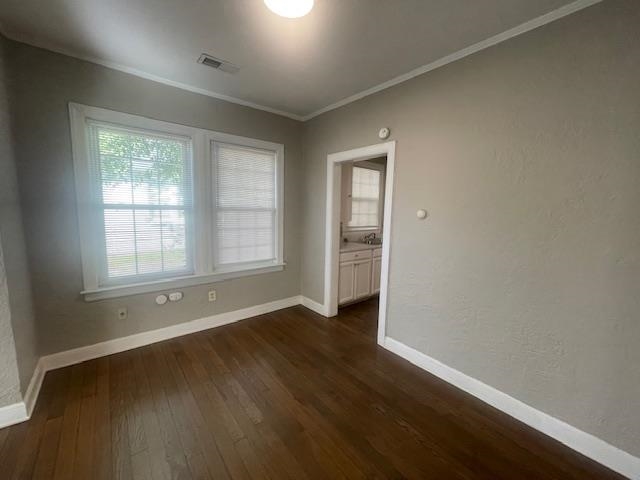 754 McConnell Street Memphis, TN 38112 - Photo 5 of 16 an empty room with wooden floor and windows