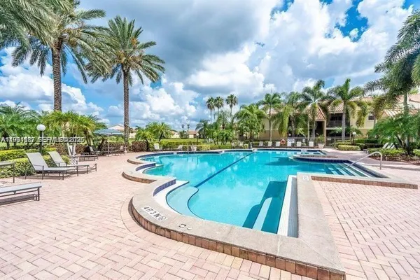 a view of swimming pool with outdoor seating and plants