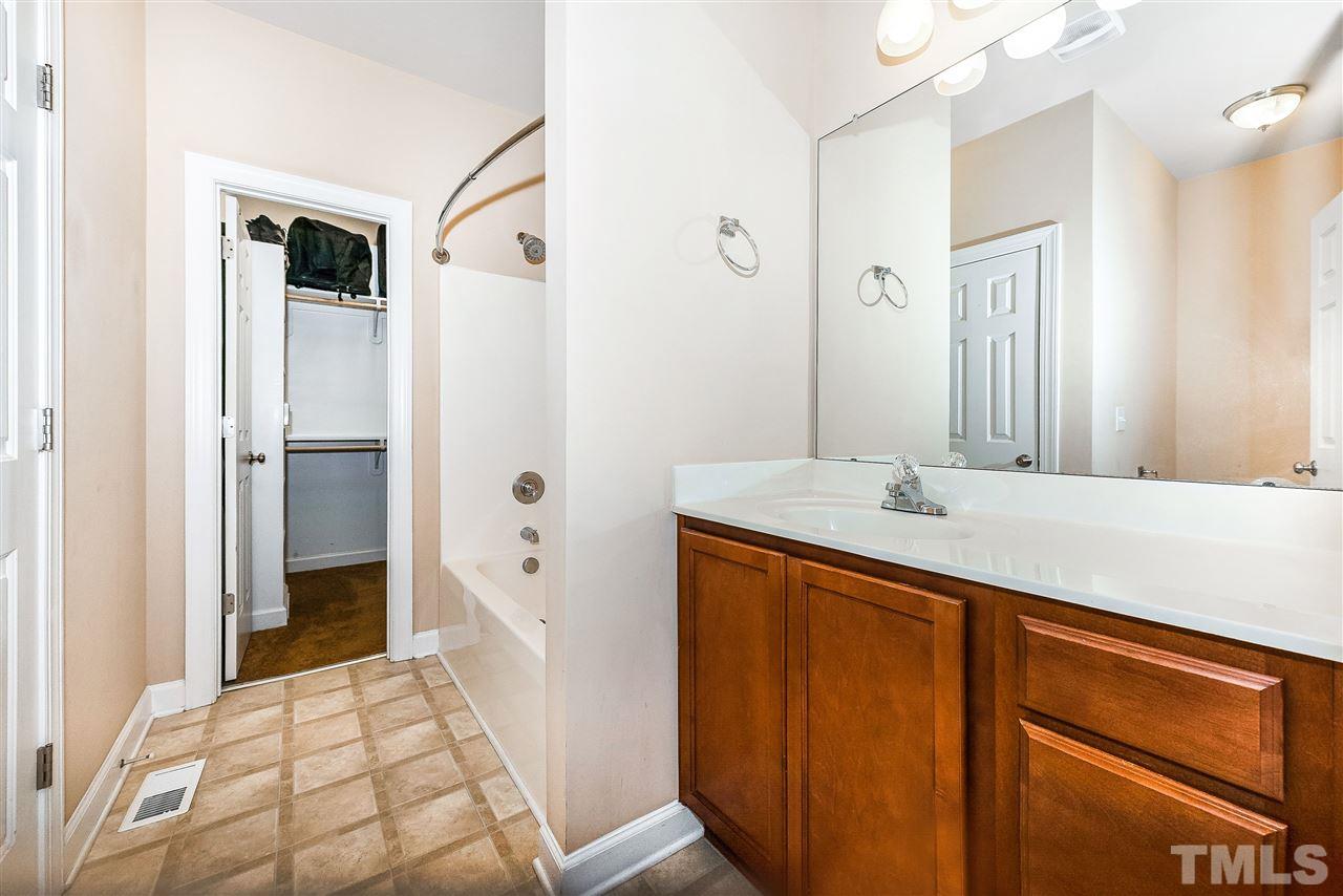 224 Cooke Street Raleigh, NC 27601 - Photo 14 of 17 a bathroom with a double vanity sink and mirror