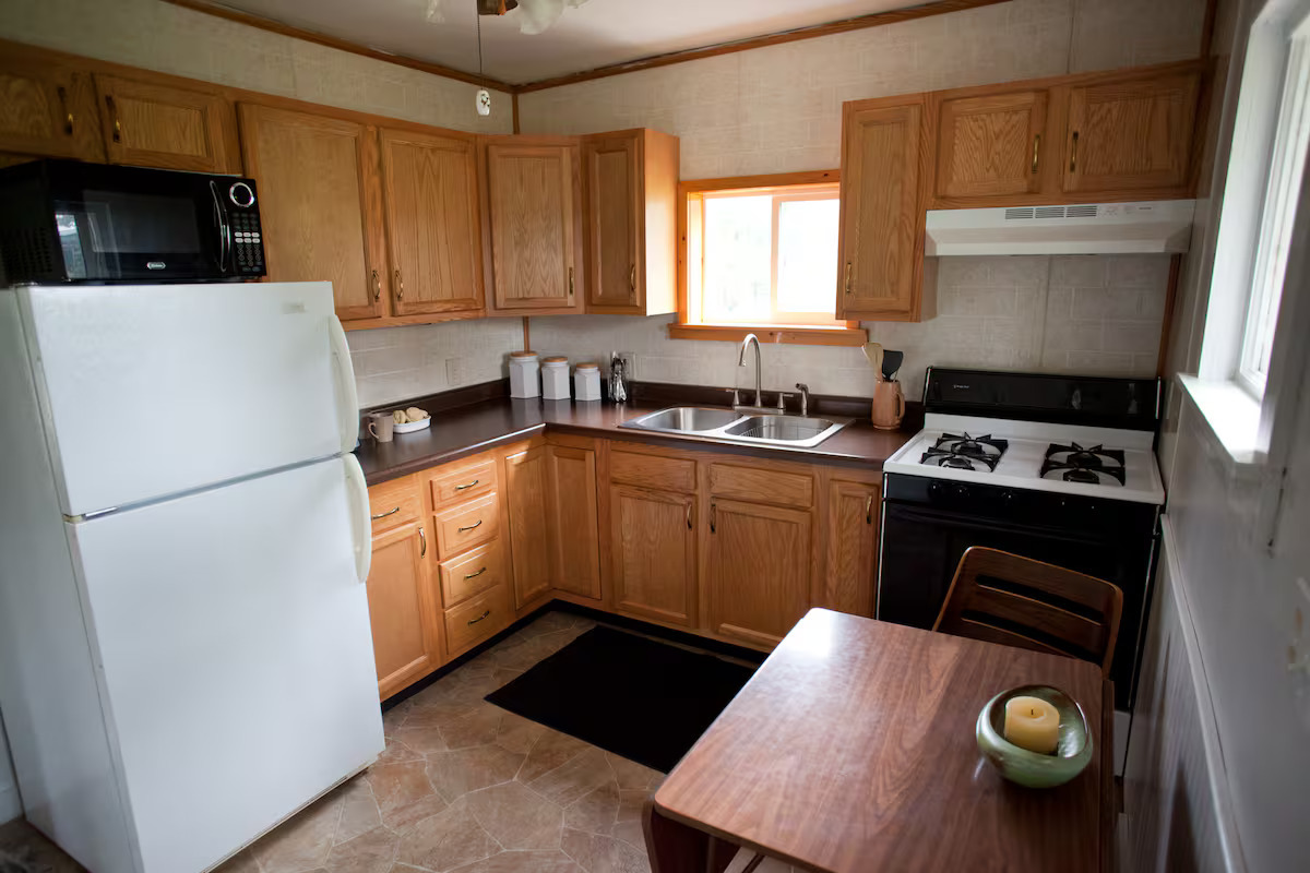 707 Monroe Street Oregon, IL 61061 - Photo 2 of 8 a kitchen with a refrigerator and a stove top oven