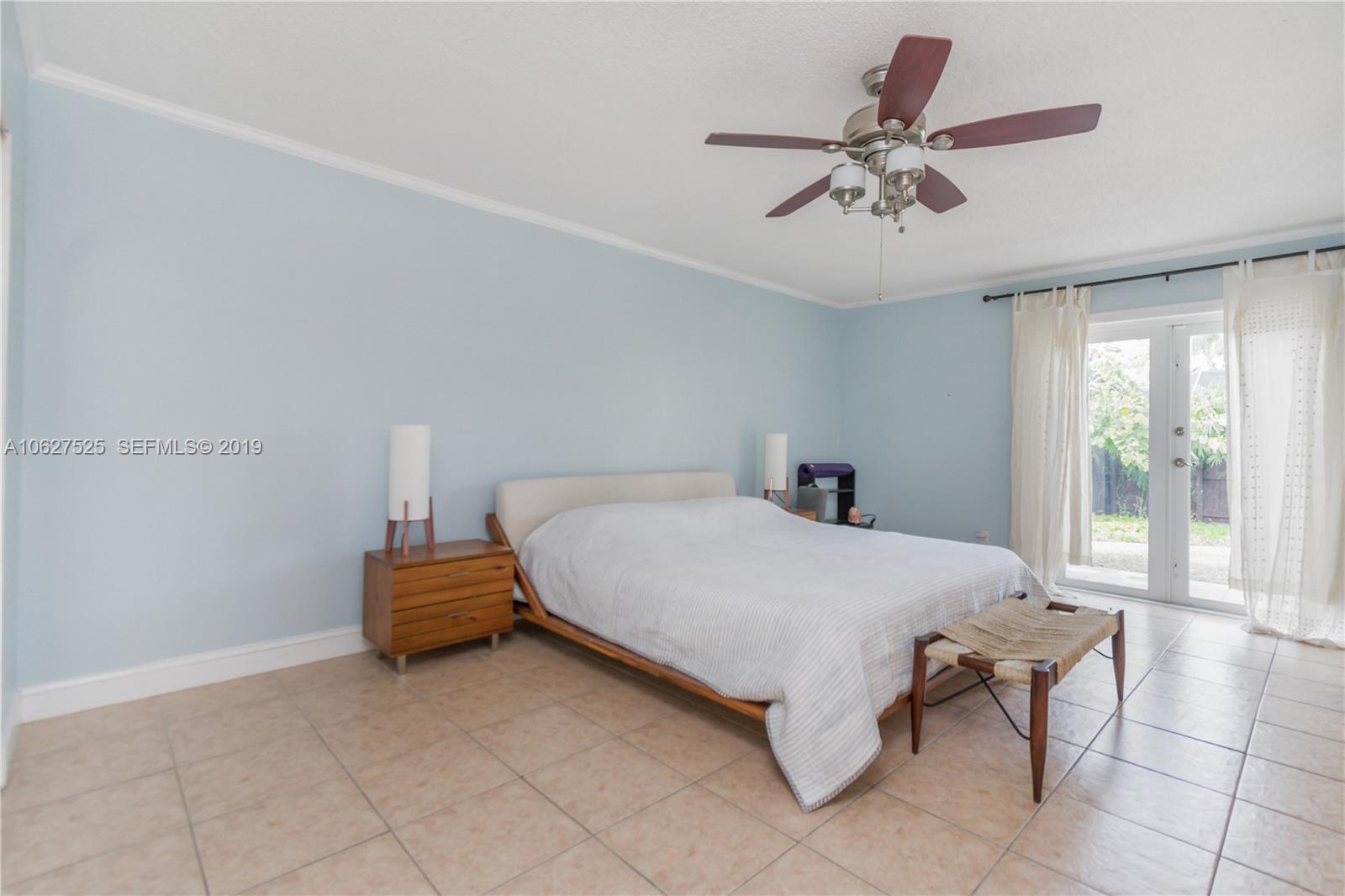 3339 West Park Road Hollywood, FL 33021 - Photo 12 of 28 a spacious bedroom with a bed and window