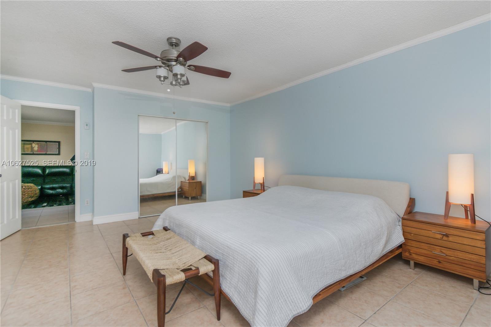 3339 West Park Road Hollywood, FL 33021 - Photo 13 of 28 a bedroom with a bed and a chandelier