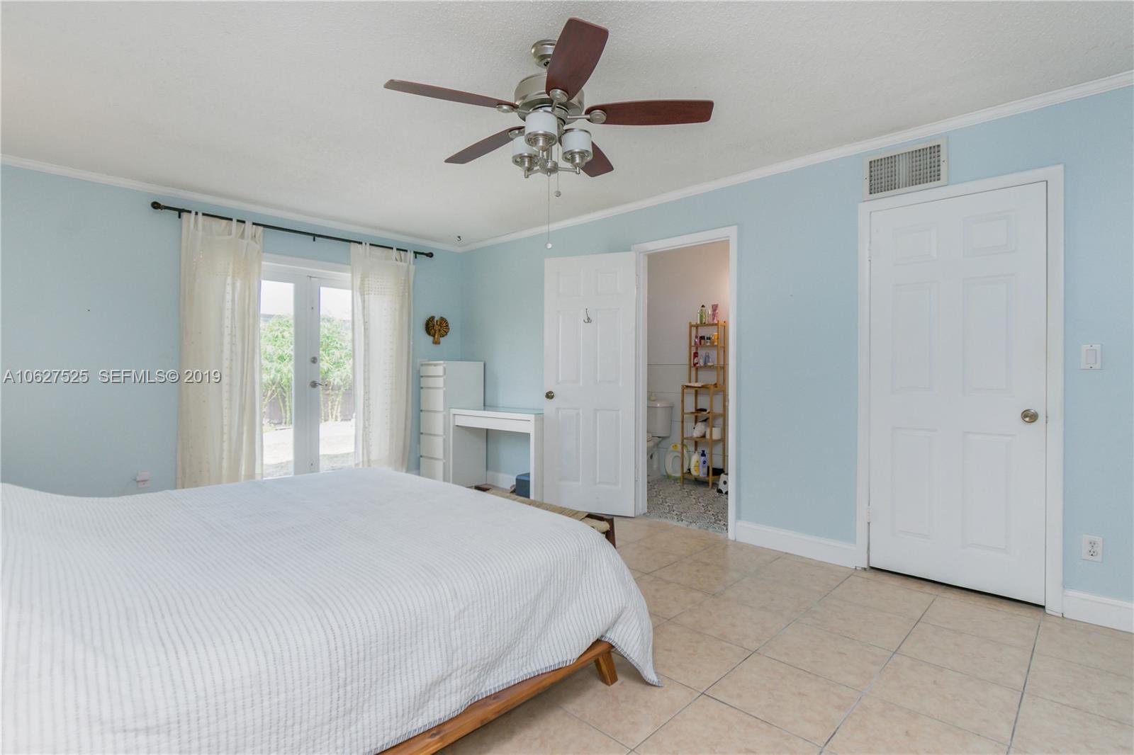 3339 West Park Road Hollywood, FL 33021 - Photo 14 of 28 a bedroom with a bed and a ceiling fan