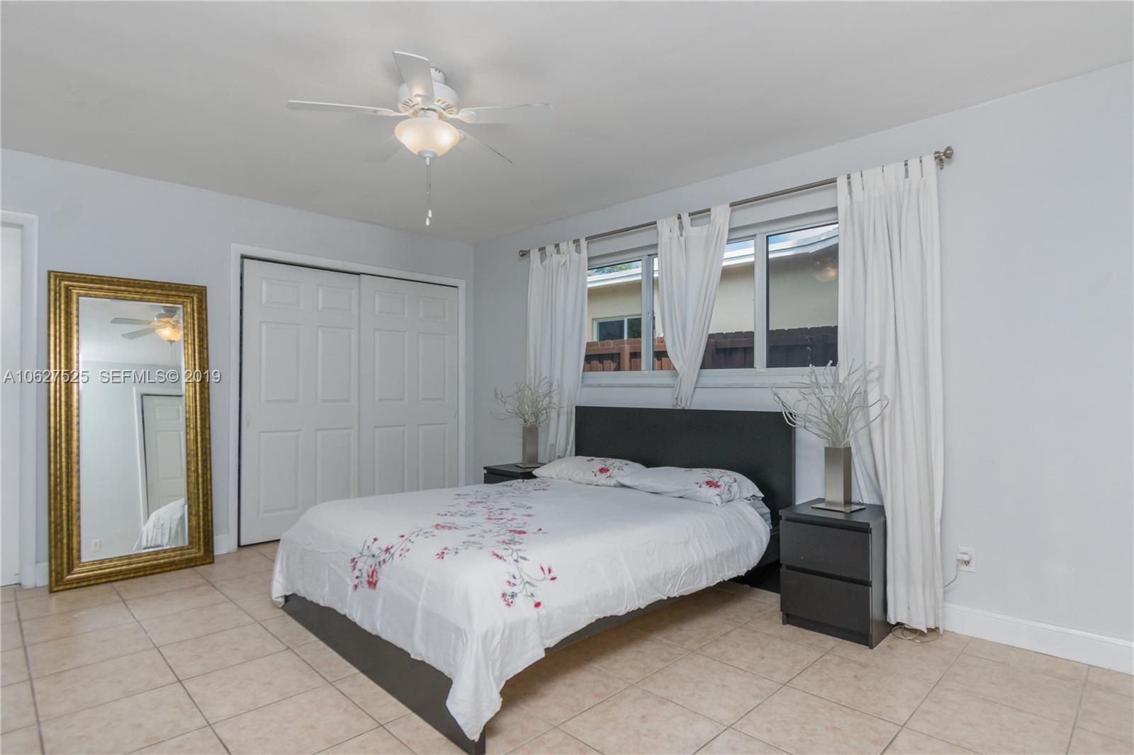 3339 West Park Road Hollywood, FL 33021 - Photo 16 of 28 a bedroom with a bed and a chandelier