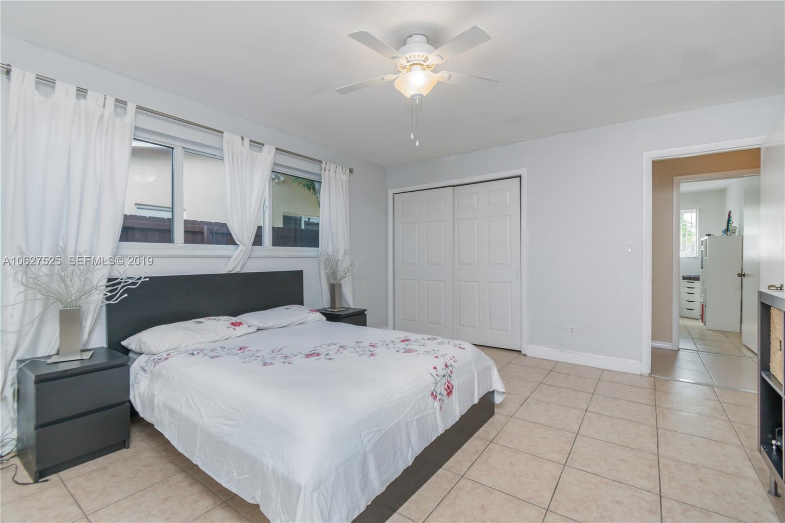 3339 West Park Road Hollywood, FL 33021 - Photo 17 of 28 a bedroom with a bed and a chandelier