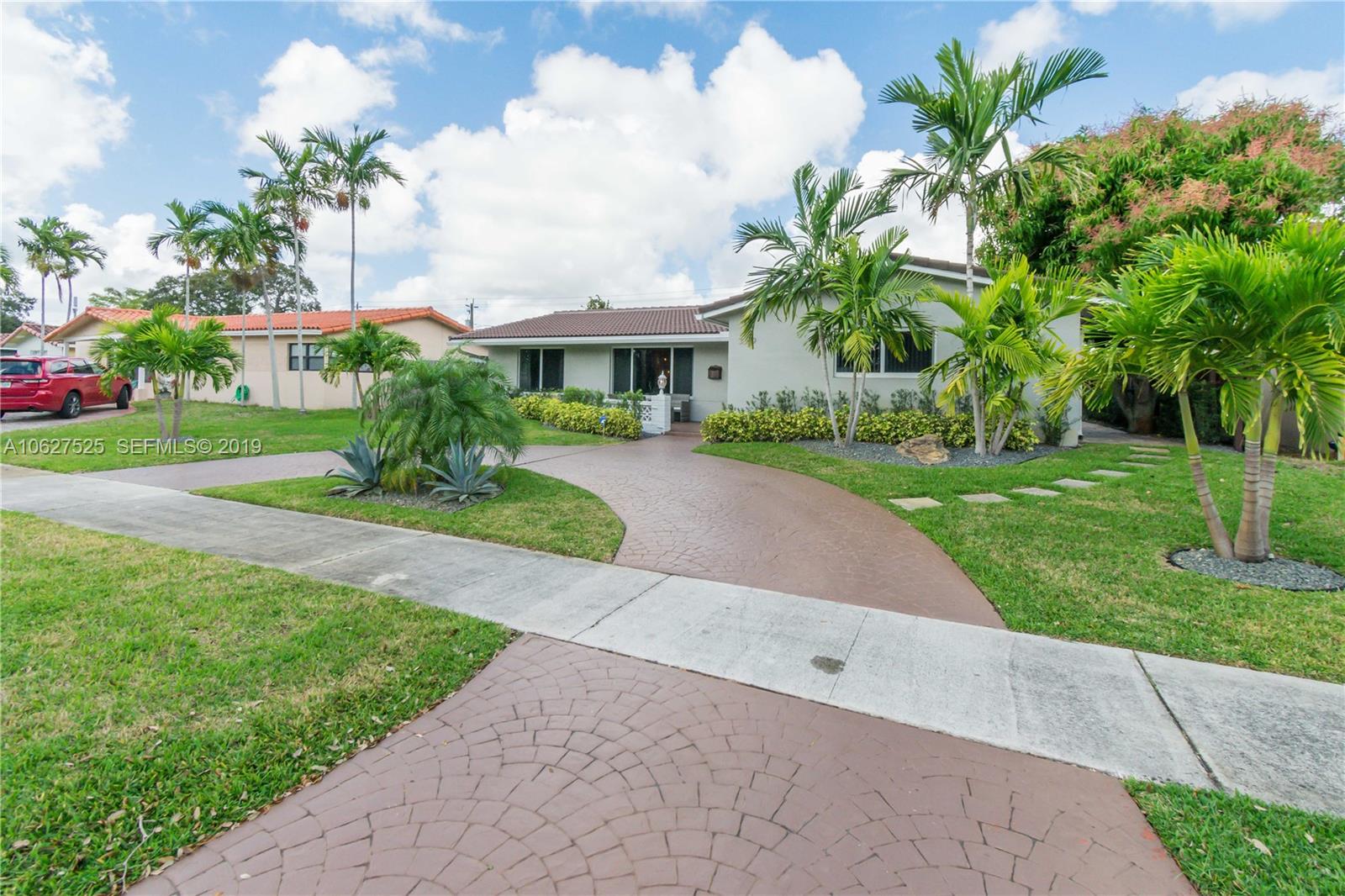 3339 West Park Road Hollywood, FL 33021 - Photo 3 of 28 a front view of a house with a yard and potted plants