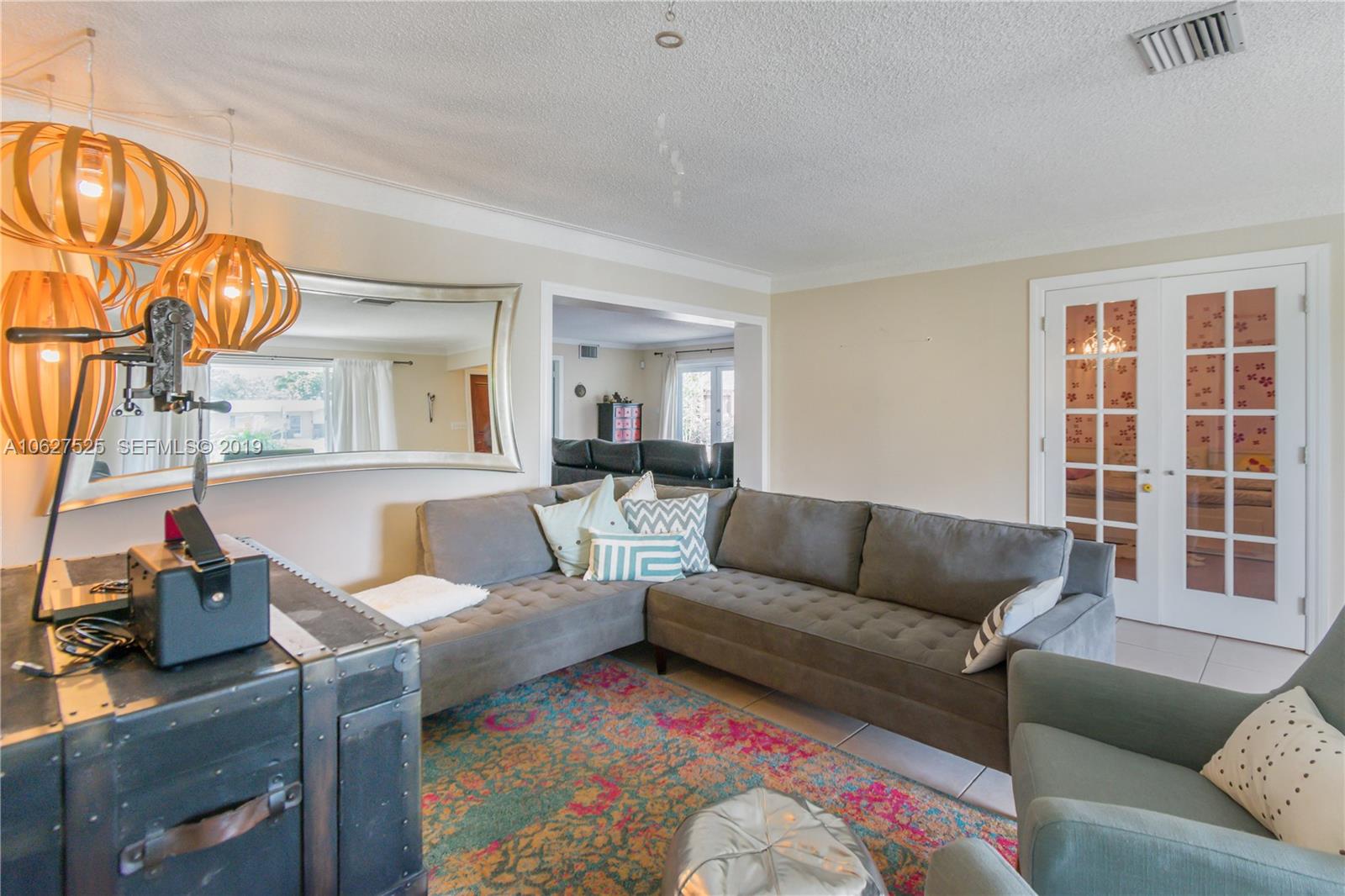 3339 West Park Road Hollywood, FL 33021 - Photo 6 of 28 a living room with furniture and a large window