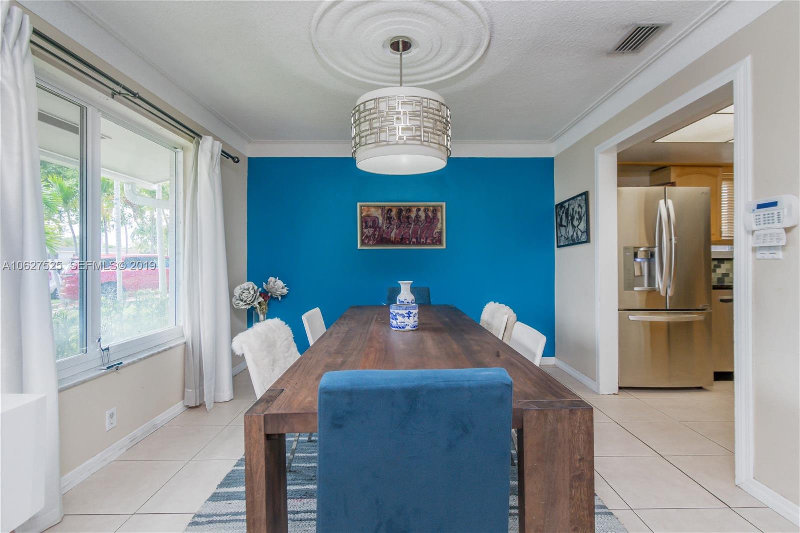 3339 West Park Road Hollywood, FL 33021 - Photo 7 of 28 a view of a dining room with furniture and chandelier