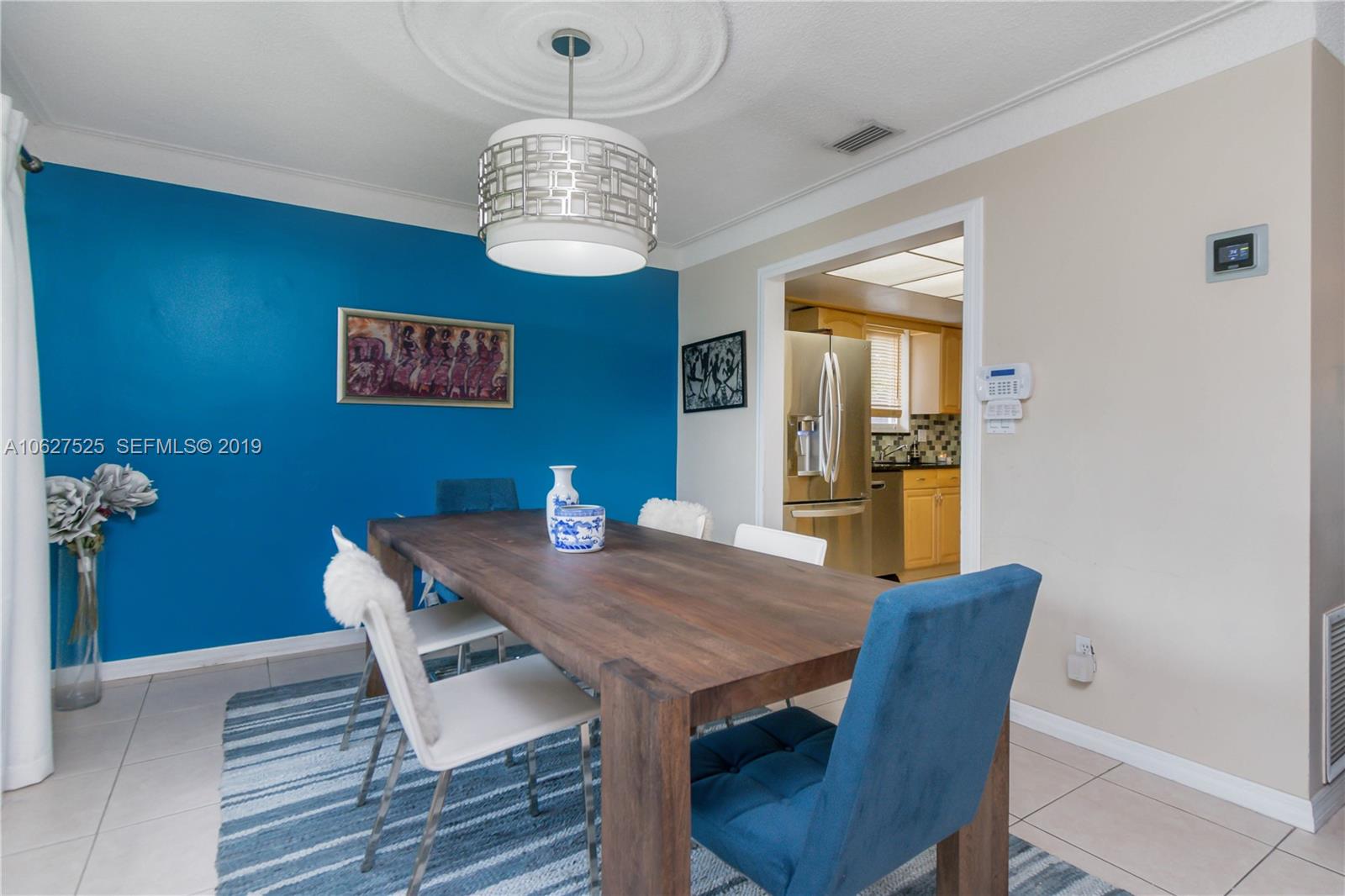 3339 West Park Road Hollywood, FL 33021 - Photo 8 of 28 a view of a dining room with furniture wooden floor and chandelier